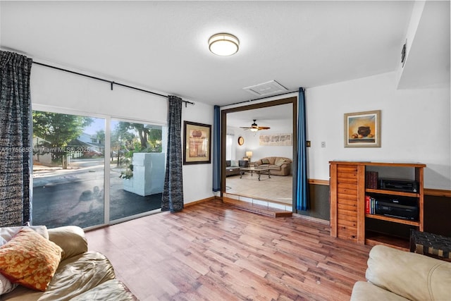 living room featuring baseboards and wood finished floors