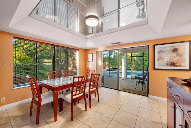 dining space with visible vents, baseboards, and light tile patterned flooring