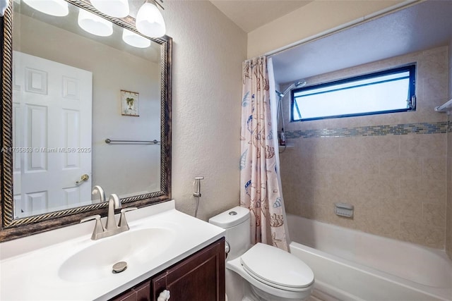 full bathroom featuring toilet, vanity, shower / bath combination with curtain, and a textured wall