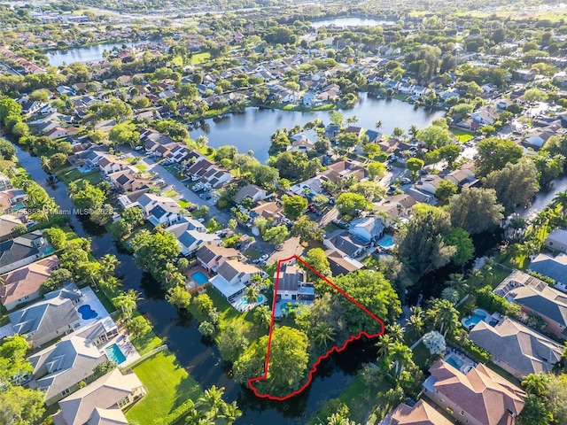 bird's eye view featuring a water view and a residential view