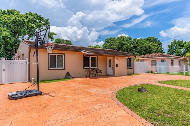 6830 SW 5th Ter, Miami, FL 33144 - ranch-style house with a front lawn, fence, stucco siding, a patio area, and a gate