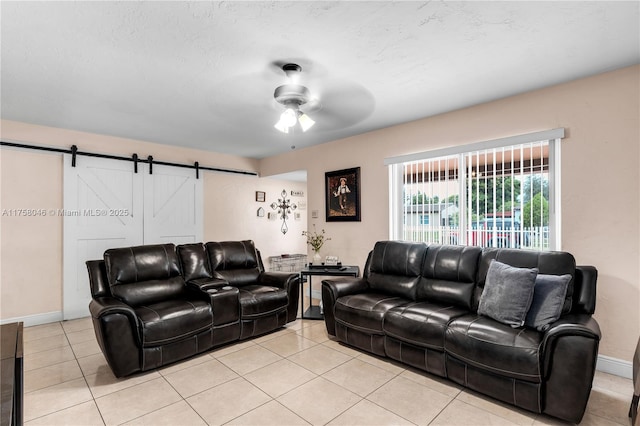 6830 SW 5th Ter, Miami, FL 33144 - living room with light tile patterned floors, a barn door, baseboards, and ceiling fan