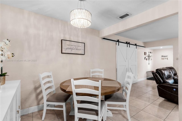 6830 SW 5th Ter, Miami, FL 33144 - dining room featuring visible vents, baseboards, beam ceiling, light tile patterned flooring, and a barn door