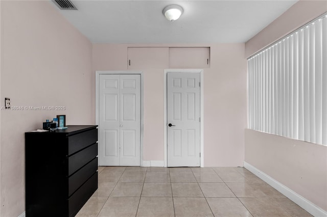 6830 SW 5th Ter, Miami, FL 33144 - bedroom with light tile patterned floors, visible vents, baseboards, and a closet