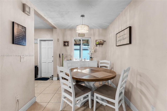 6830 SW 5th Ter, Miami, FL 33144 - dining area with light tile patterned floors, a notable chandelier, and baseboards