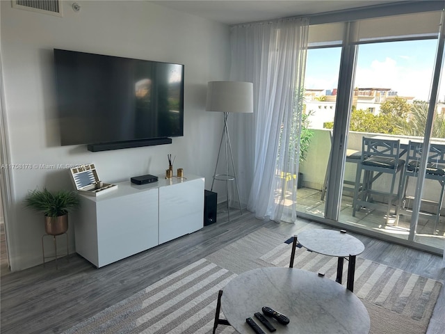 living area with wood finished floors and visible vents