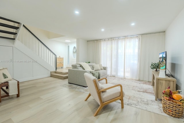 living area featuring stairway, recessed lighting, and light wood-style floors