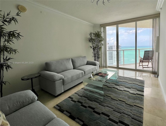 living area featuring a textured ceiling, a water view, baseboards, ornamental molding, and expansive windows