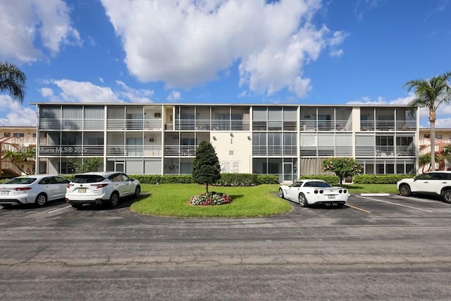 view of building exterior with uncovered parking