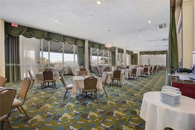 carpeted dining room with recessed lighting, visible vents, and a textured ceiling