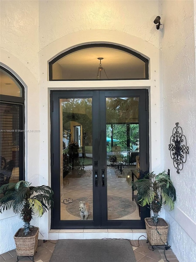 doorway to property with stucco siding and french doors