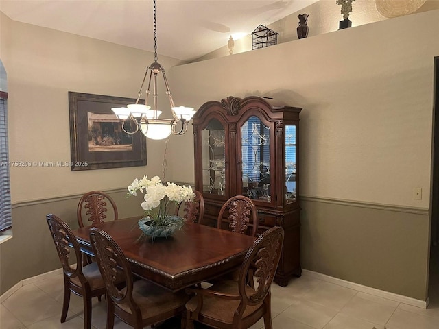 dining room with a chandelier, vaulted ceiling, baseboards, and light tile patterned floors