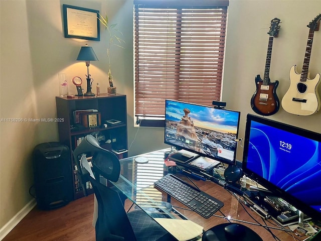 office space with baseboards and wood finished floors