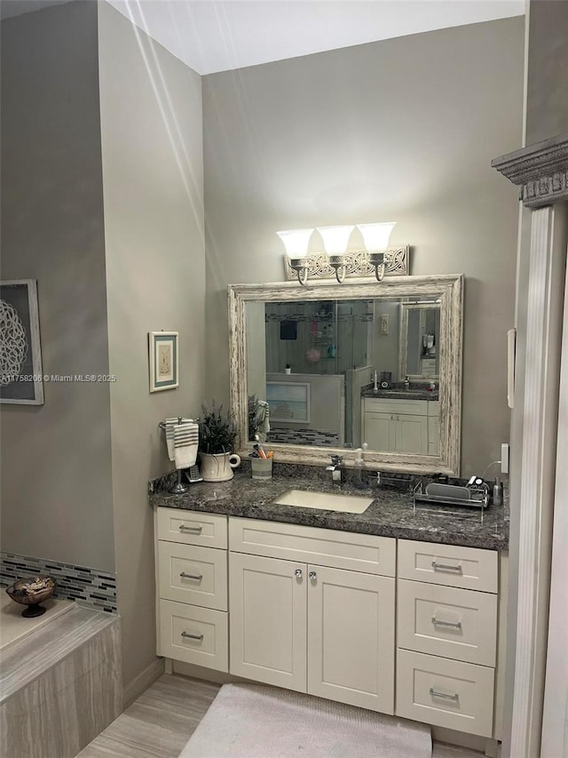 bathroom with vanity and wood finished floors