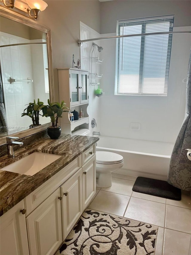 bathroom with tile patterned flooring, bathtub / shower combination, vanity, and toilet