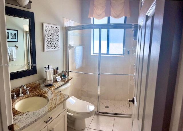 full bathroom featuring a stall shower, tile patterned flooring, vanity, and toilet