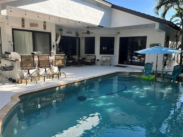 outdoor pool featuring a patio area and ceiling fan