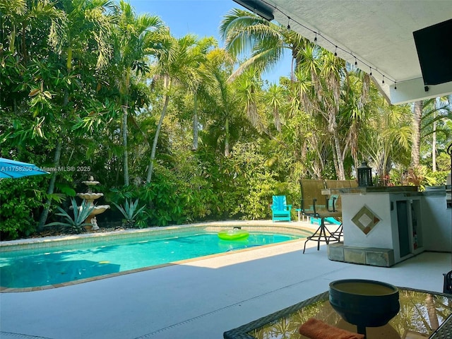 view of swimming pool with a fenced in pool and a patio