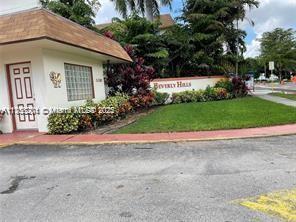 community / neighborhood sign with a lawn