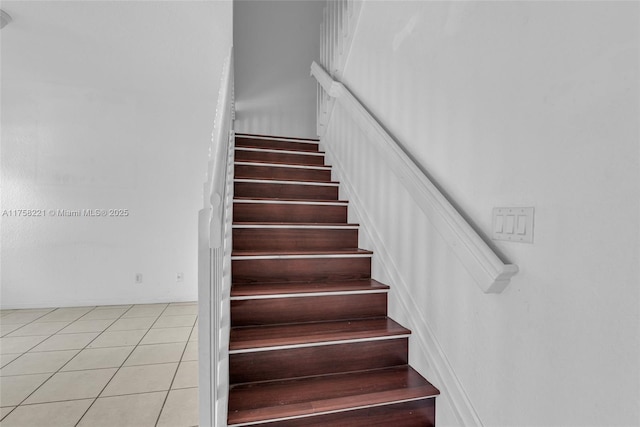 stairs featuring tile patterned flooring