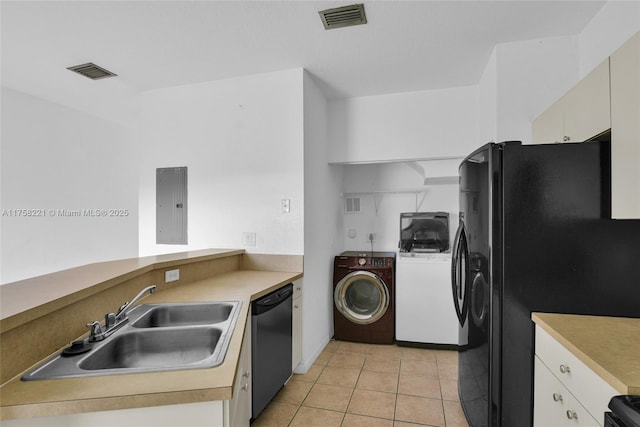 kitchen featuring electric panel, visible vents, dishwasher, washer and dryer, and a sink