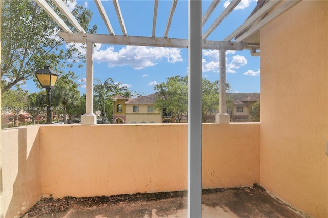 view of patio featuring a balcony and a pergola