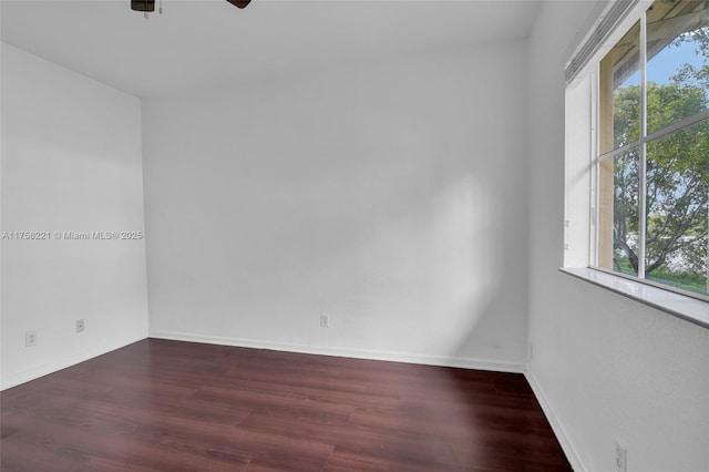 spare room featuring ceiling fan, wood finished floors, and baseboards