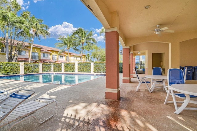 community pool featuring a patio area, fence, and a ceiling fan