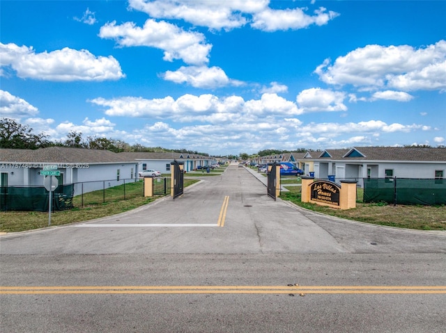 view of road featuring a gate and a residential view