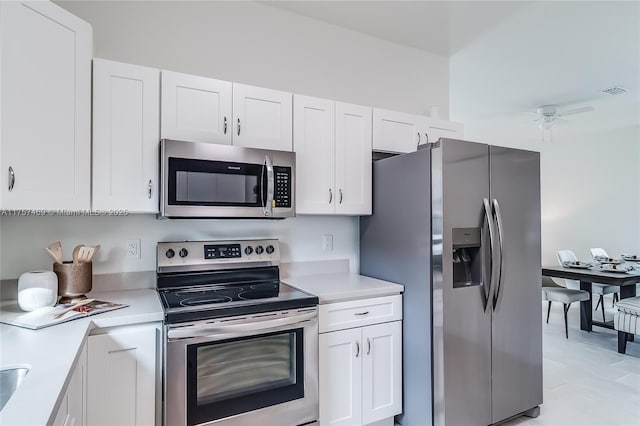 kitchen with white cabinets, ceiling fan, light countertops, and appliances with stainless steel finishes