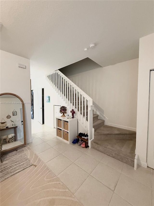 staircase with tile patterned floors