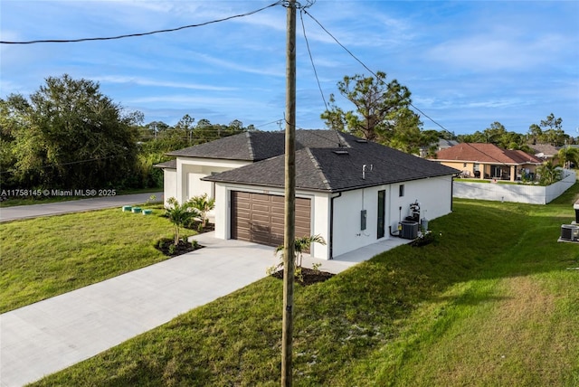 3318 9th St SW, Lehigh Acres, FL 33976 - exterior space with central AC unit, concrete driveway, a lawn, roof with shingles, and stucco siding