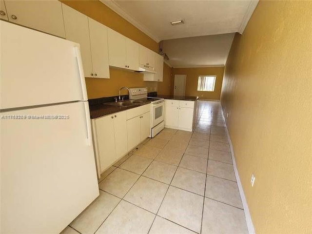 kitchen with white appliances, light tile patterned floors, dark countertops, ornamental molding, and a sink