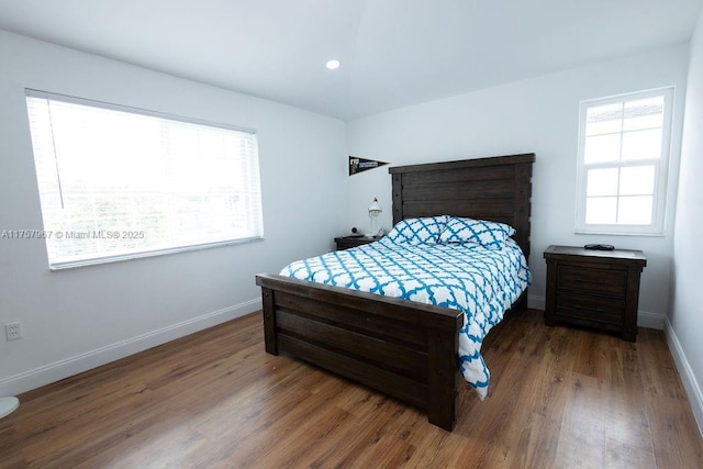 bedroom with recessed lighting, baseboards, and wood finished floors