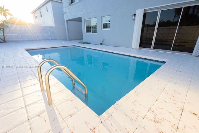 view of pool featuring a patio, fence, and a fenced in pool