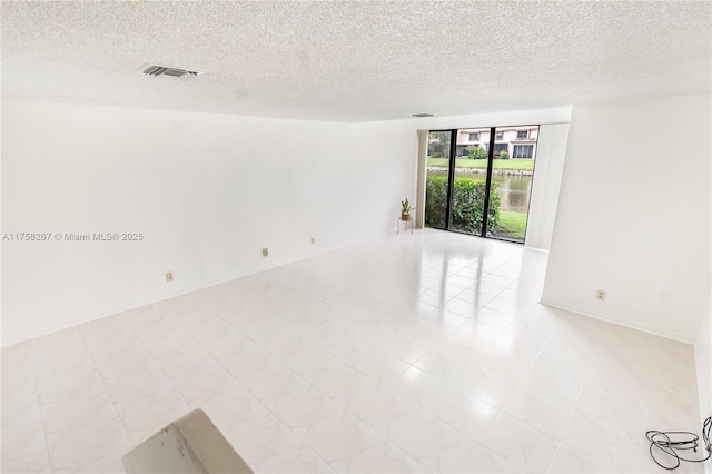 spare room with visible vents and a textured ceiling