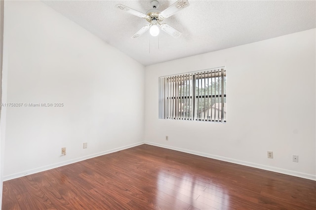 empty room with a textured ceiling, wood finished floors, a ceiling fan, and baseboards