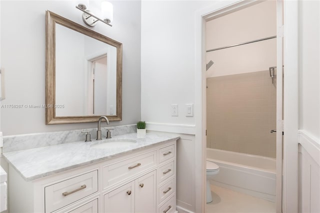 full bathroom with tub / shower combination, vanity, and toilet