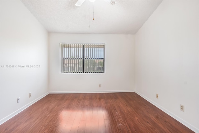 spare room featuring a ceiling fan, a textured ceiling, baseboards, and wood finished floors