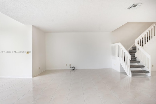 empty room featuring stairs and visible vents