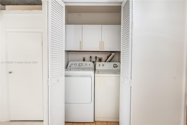 laundry room featuring cabinet space, washer and clothes dryer, and light tile patterned floors