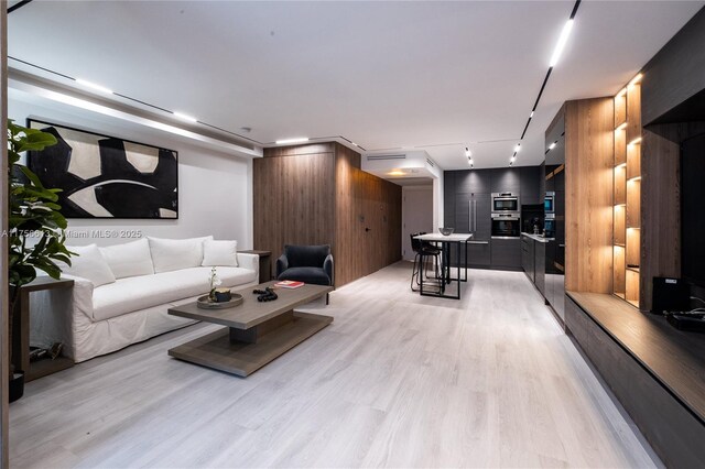 2301 Collins Ave Unit 432, Miami Beach, FL 33139 - living area featuring light wood finished floors