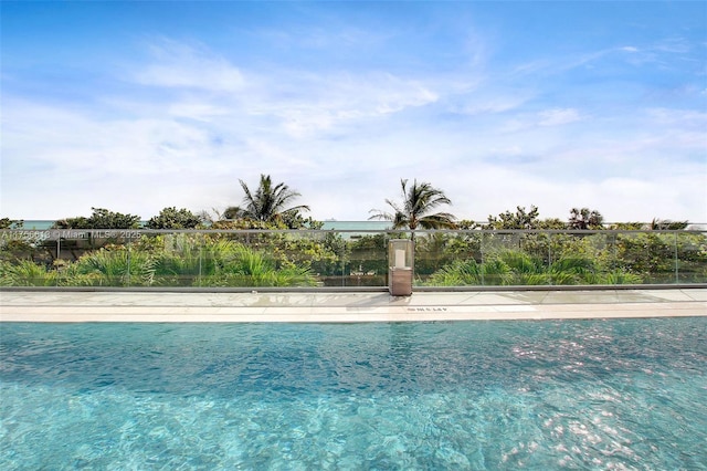 view of home's community featuring fence and a swimming pool