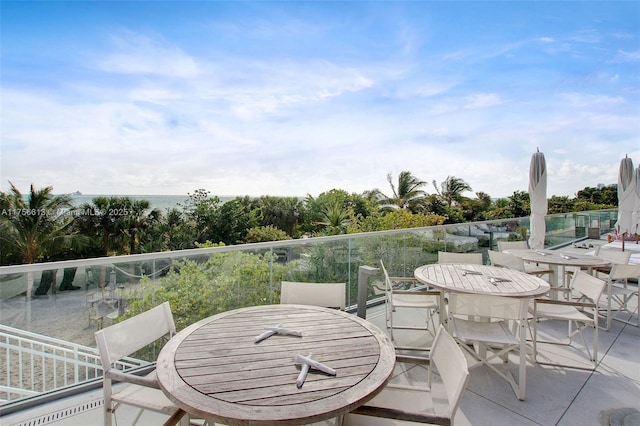 view of patio featuring a balcony and outdoor dining space