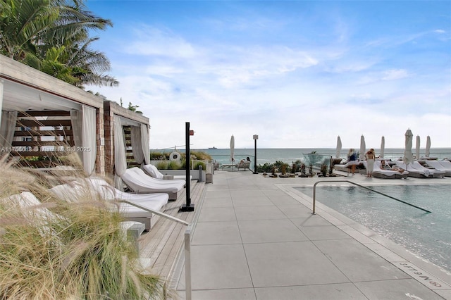 view of swimming pool with a water view