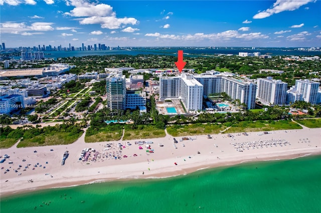 aerial view featuring a view of the beach, a city view, and a water view