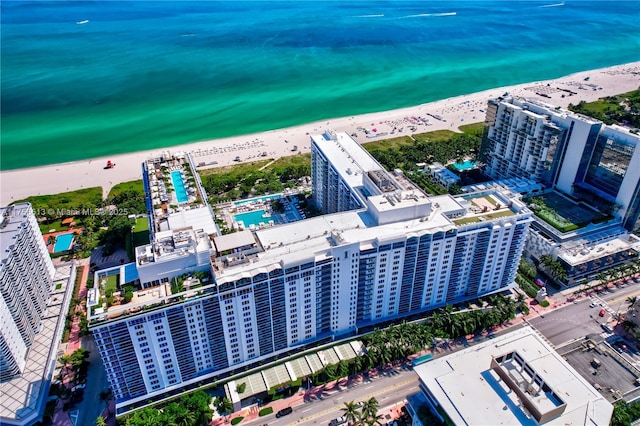 aerial view featuring a water view, a city view, and a view of the beach