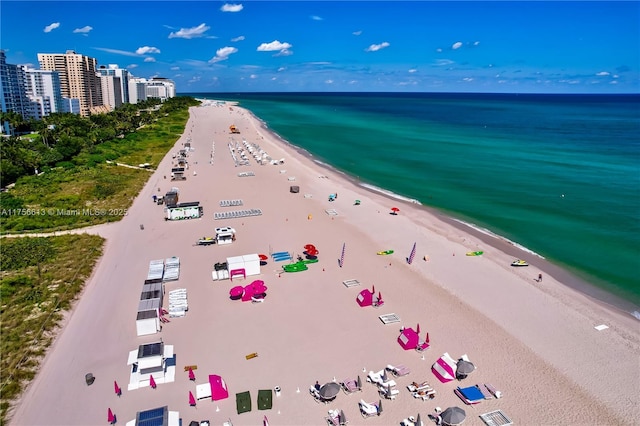 birds eye view of property with a water view, a view of city, and a view of the beach