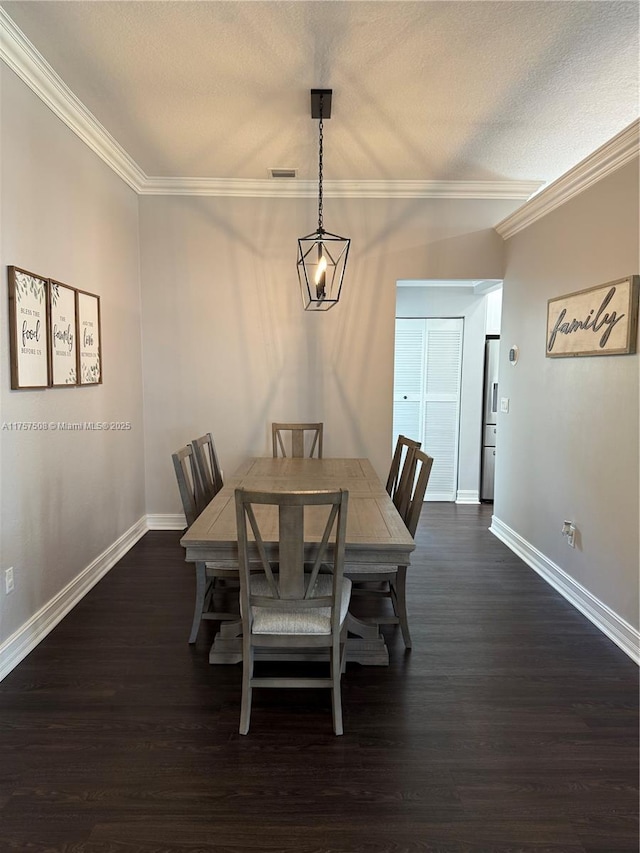 dining area featuring crown molding, visible vents, dark wood finished floors, and baseboards