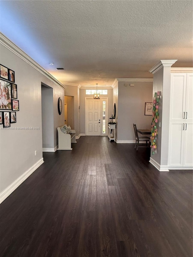 entrance foyer with dark wood-style floors, baseboards, and crown molding